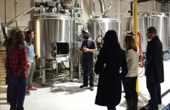 A group of visitors at a brewery using PPR pipe